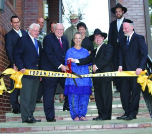 Ribbon-cutting ceremony at the Max and Anna Krupnick Torah Links Center. Second from the right, in the front row, is Rabbi Yisroel Tzvi Serebrowski, founding rabbi and director, Torah Links of South Jersey. Photo courtesy of Rabbi Serebrowski